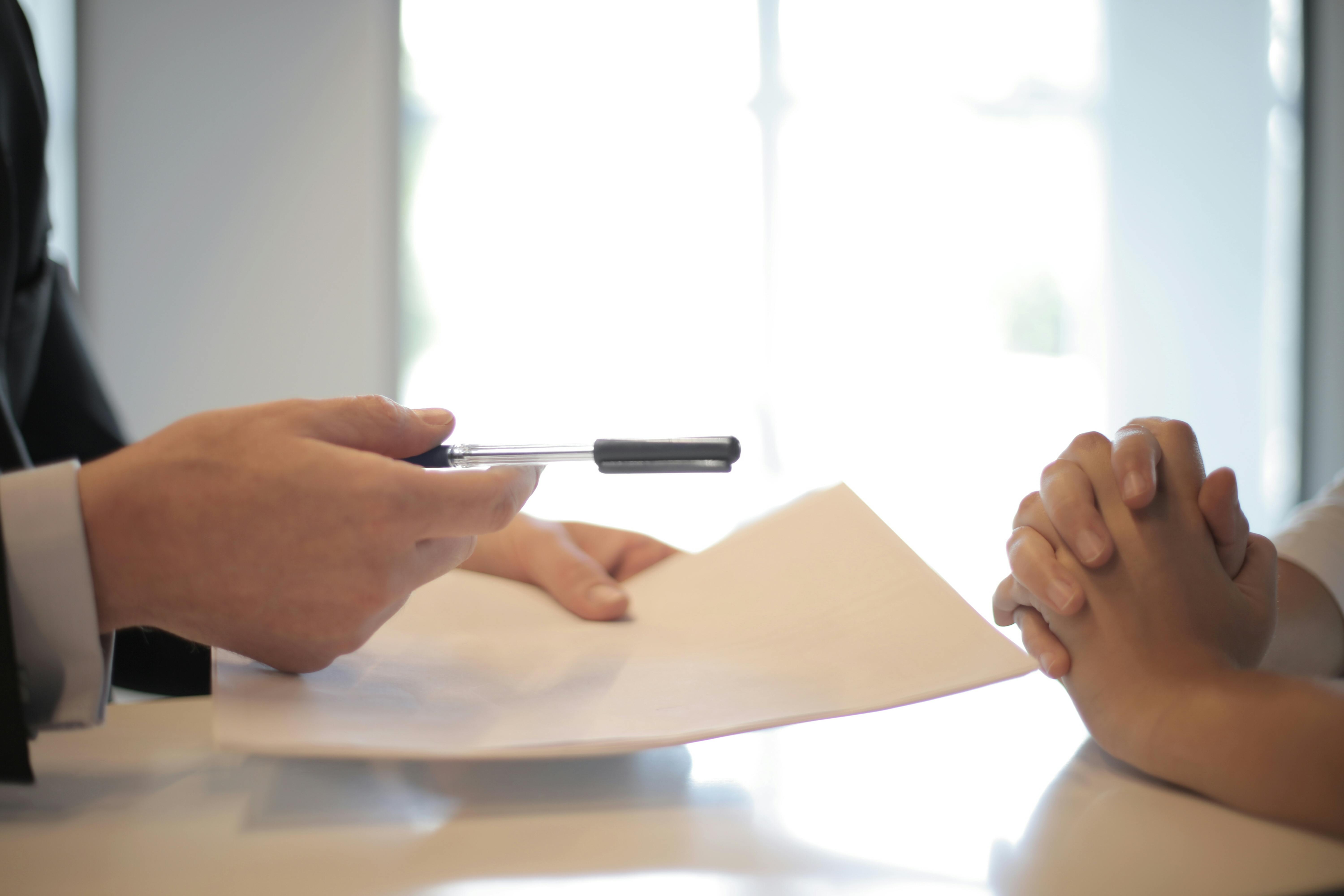Free Crop businessman giving contract to woman to sign Stock Photo